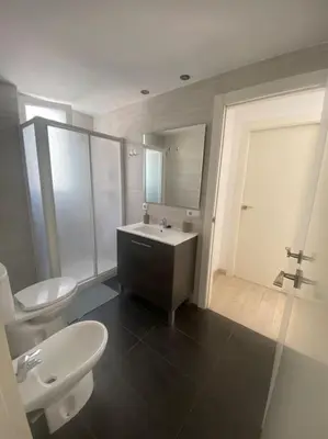 a bedroom with a bed with a blue and white comforter at VALENCIA RENT APARTS MILAGROSA 1 in Valencia