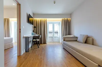 a living room with a couch and a desk at Petit Palace Plaza de la Reina in Valencia