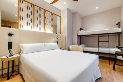 a bedroom with a bed and a bunk bed at Petit Palace Plaza de la Reina in Valencia
