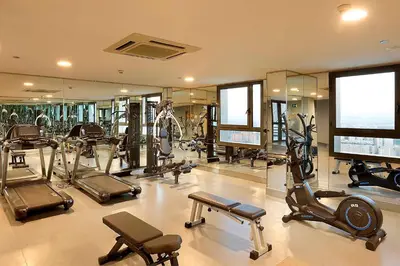a gym with several treadmills and elliptical machines at Eurostars Gran Valencia in Valencia