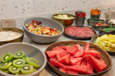 a table topped with bowls of fruits and vegetables at Catalonia Excelsior in Valencia