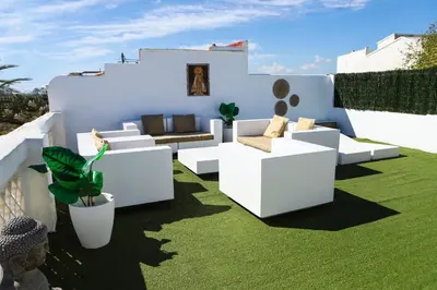 a living room with white furniture and green grass at Valencia Luxury - Malvarrosa Beach in Valencia