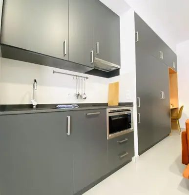 a kitchen with gray cabinets and a sink at RUBEN VELA - LOFT CLOSE to RUSSAFA (SOHO) in Valencia