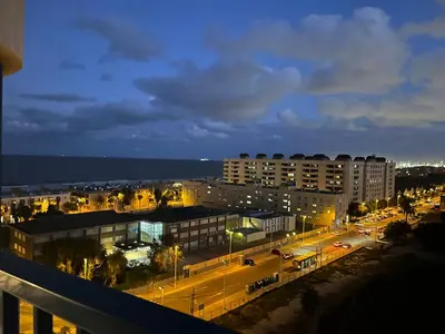 a view of a city at night with street lights at Ático frente al mar, PataconaBlue, complejo vacacional in Valencia