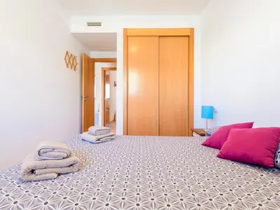 a bedroom with a bed with towels on it at Apartment Las Dunas by Interhome in Moncófar