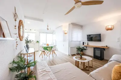 a living room with white walls and a ceiling fan at Lux Penthouse Mediterranean views Beach front in Puerto de Sagunto