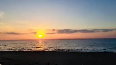 a sunset over the ocean with the sun setting at Lux Penthouse Mediterranean views Beach front in Puerto de Sagunto