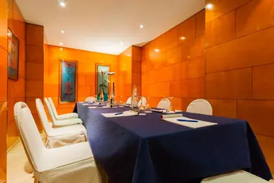 a conference room with a long table and white chairs at Hotel Villacarlos in Valencia