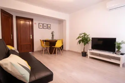 a living room with a couch and a tv and a table at Marina Flat by Concept Flats in Valencia