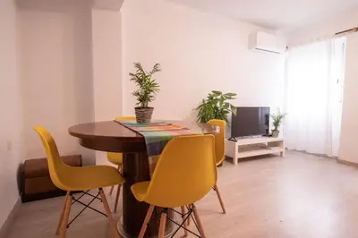 a dining room with a table and yellow chairs at Marina Flat by Concept Flats in Valencia