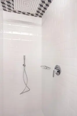 a shower in a white bathroom with a shower head at One Shot Reina Victoria in Valencia