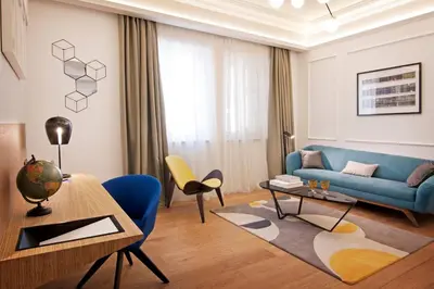 a living room with a blue couch and a table at One Shot Reina Victoria in Valencia