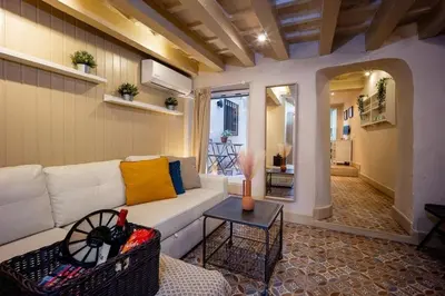 a living room with a white couch and a table at Lovely Coquette loft, heart of cuitat vella El Carmen Valencia in Valencia