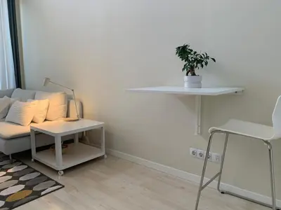 a living room with a couch and a table with a plant at Manises POLIGONO in Manises