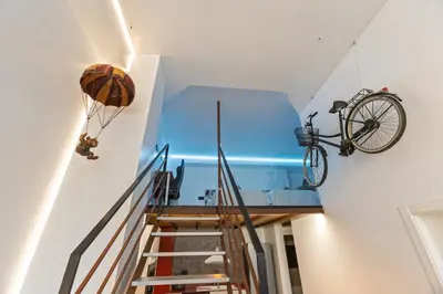 a room with a bike on the wall and a staircase at Loft Nou Benicalap - Housevanlive in Valencia