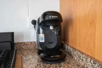 a black coffee maker sitting on a counter at Excelente apartamento en 2ª línea de playa by Hometels in Puerto de Sagunto