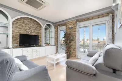 a living room with two couches and a tv at Malvarrosa Las Arenas I in Valencia