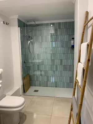 a bathroom with a glass shower with a toilet at Alex- DUPLEX APARTMENT- City in Valencia