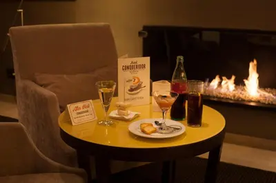 a table with a bottle of wine and wine glasses at Hotel Conqueridor in Valencia