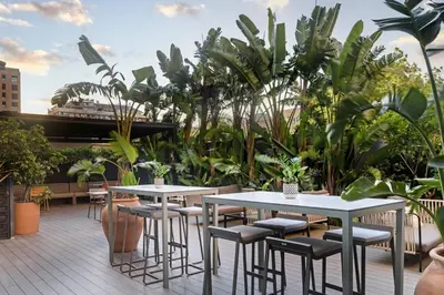 a patio with tables and chairs and plants at AC Hotel Valencia by Marriott in Valencia