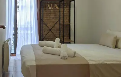 a bedroom with a large bed with towels on it at Enjoy Apartment 4 pax at Ruzafa with sunny terrace in Valencia