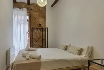 a large white bed in a room with a window at Enjoy Apartment 4 pax at Ruzafa with sunny terrace in Valencia