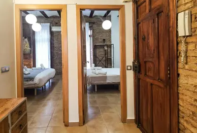 a hallway with a room with two beds and a door at Enjoy Apartment 4 pax at Ruzafa with sunny terrace in Valencia