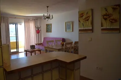 a kitchen and living room with a couch and a table at Apartamento Florazar 2, 10ºC Cullera in Faro de Cullera