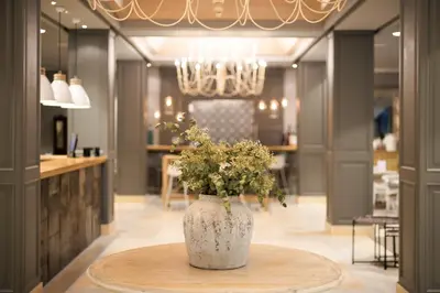 a vase with flowers on a table in a room at Vincci Lys in Valencia