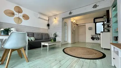a living room with a couch and a table at New Cozy Beach apartment, WiFi in Valencia