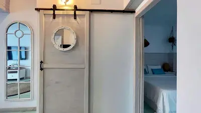 a door leading to a bedroom with a bed at New Cozy Beach apartment, WiFi in Valencia