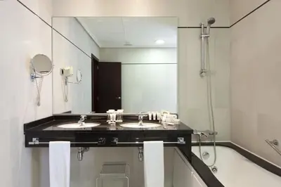 a bathroom with two sinks and a large mirror at Hotel Valencia Center in Valencia