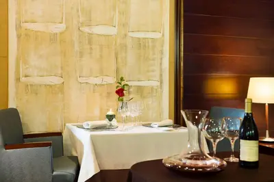 a table with a white table cloth and wine glasses at Hotel Valencia Center in Valencia