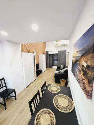 a living room with a table and chairs and a couch at Carbonell 1 in Valencia