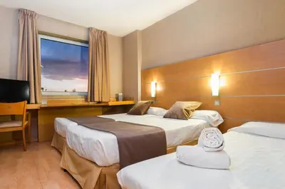 a hotel room with two beds and a window at Posadas De España Paterna in Paterna