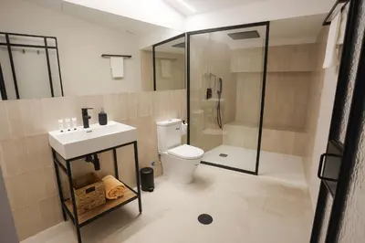 a bathroom with a toilet and a sink and a shower at Mythic Valencia in Valencia