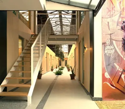 a hallway with stairs in a building with graffiti at Mythic Valencia in Valencia