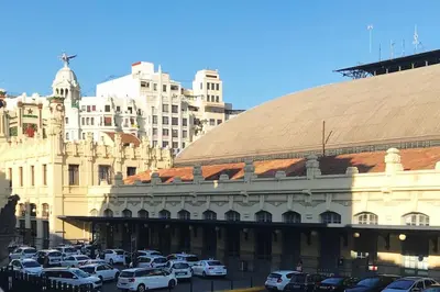 a parking lot with cars parked in front of a building at Vlc Center 4 Room Apartment in Valencia
