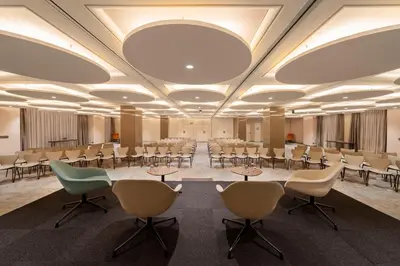 a conference room with chairs and tables and a large ceiling at SH Valencia Palace in Valencia