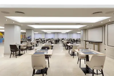a dining room with tables and chairs in a building at Exe Rey Don Jaime in Valencia