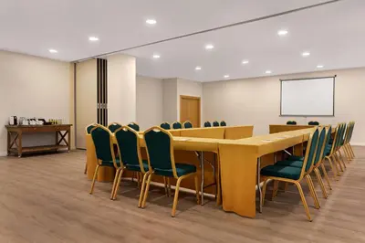 a conference room with a long table and chairs at Ramada by Wyndham Valencia Almussafes in Almussafes