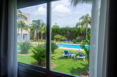 a window with a view of a swimming pool at Ramada by Wyndham Valencia Almussafes in Almussafes