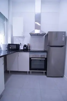 a kitchen with a stove and a refrigerator at Viveros by Concept Flats in Valencia