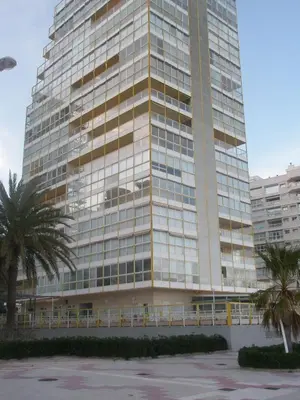 a tall building with palm trees in front of it at Florazar 3 in Cullera