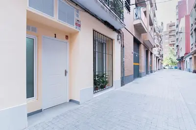 an empty street with a white door on a building at APARTAMENTOS LEO XIII in Valencia