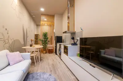 a living room with a couch and a large television at Art Lofts Gardens in Valencia