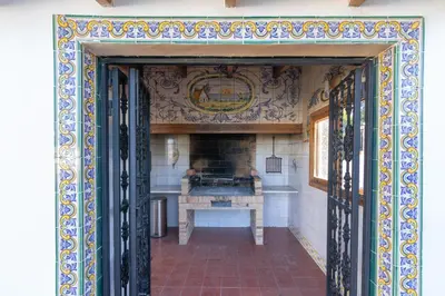 an open door into a kitchen with a stove at Villa Huerta 1 Manises, jacuzzi, sauna, piscina in Manises