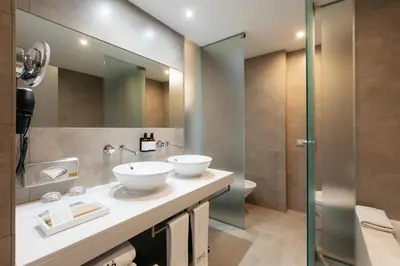 a bathroom with two sinks and a mirror at Barceló Valencia in Valencia