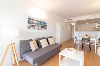 a living room with a couch and a table at Global Vacacional, Moderno apartamento en Canet al Mar in Canet de Berenguer