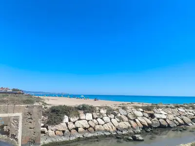 a view of a beach and the ocean at Apartamento en la playa in Tavernes de Valldigna